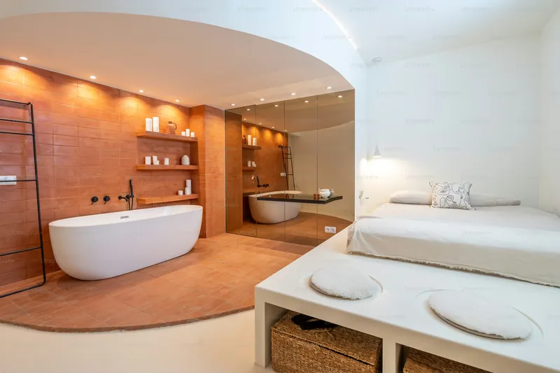 Premium spa suite with soaking tub and organised amenities
